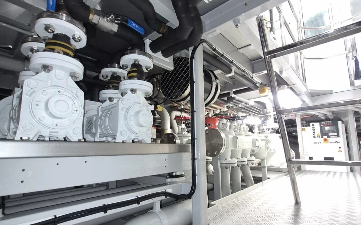 Compact yacht machinery space with pumps, pipework and service access